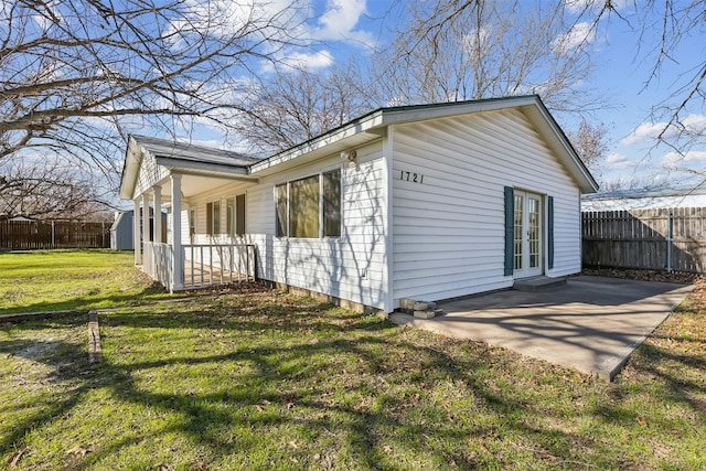 view of home's exterior with a yard and a patio