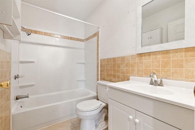 full bathroom with tile patterned floors, toilet, shower / washtub combination, vanity, and tile walls