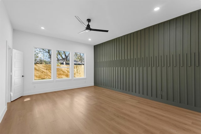 empty room with light hardwood / wood-style floors and ceiling fan