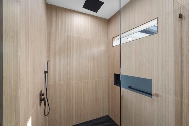 interior details featuring tiled shower