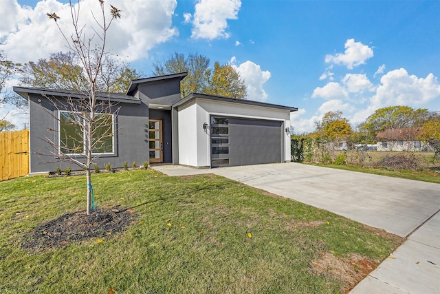 view of front of home featuring a garage and a front yard