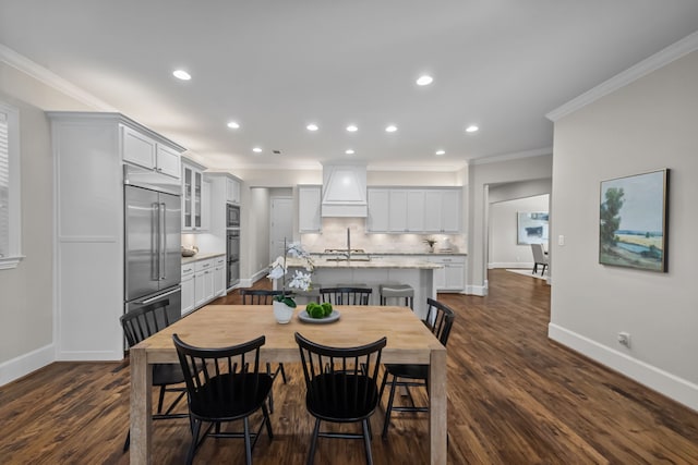 dining space featuring dark hardwood / wood-style flooring and crown molding