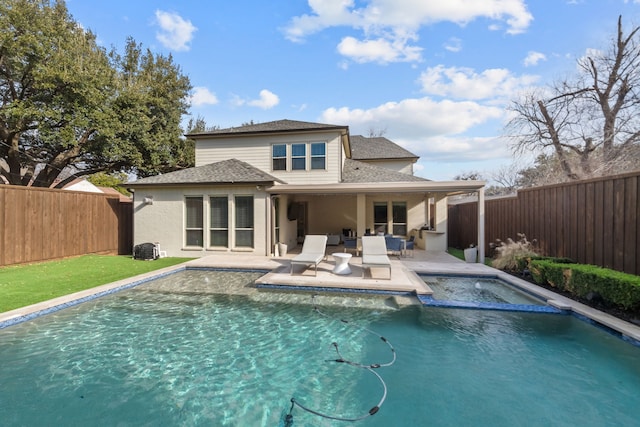 back of house featuring a fenced in pool and a patio