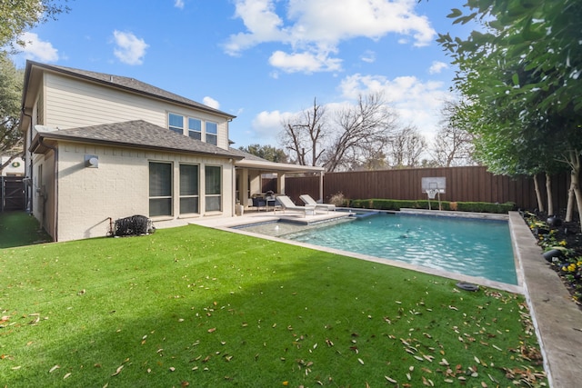 view of swimming pool featuring a lawn and a patio