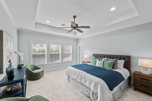 bedroom featuring a raised ceiling, ceiling fan, and light carpet