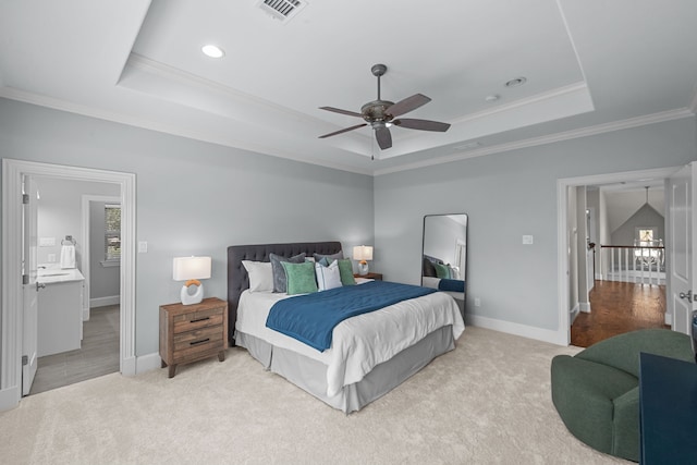 bedroom featuring a tray ceiling, ceiling fan, crown molding, and light colored carpet