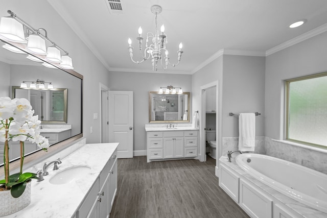 bathroom with a bathtub, ornamental molding, vanity, hardwood / wood-style flooring, and toilet