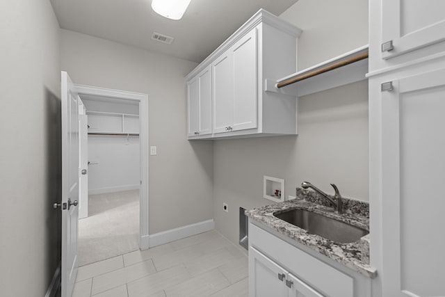 washroom featuring sink, cabinets, electric dryer hookup, hookup for a washing machine, and light colored carpet