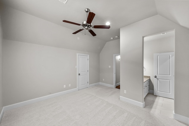 additional living space with ceiling fan, light colored carpet, and lofted ceiling