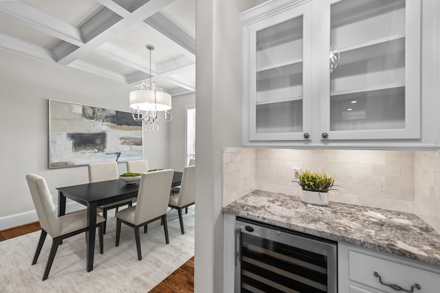 dining room with beam ceiling, wine cooler, wood-type flooring, and coffered ceiling