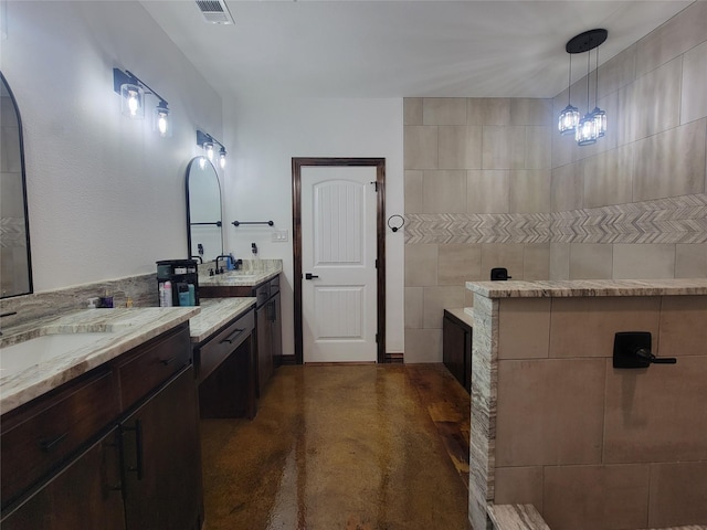 bathroom with vanity and concrete floors