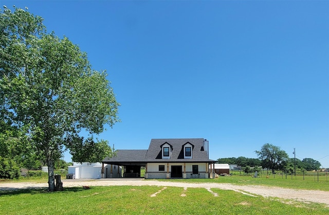 view of front of property with a carport and a front lawn