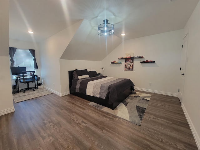 bedroom featuring dark hardwood / wood-style flooring and lofted ceiling