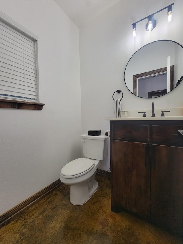 bathroom featuring concrete flooring, vanity, and toilet