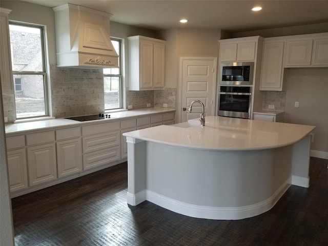 kitchen with white cabinets, built in microwave, and oven