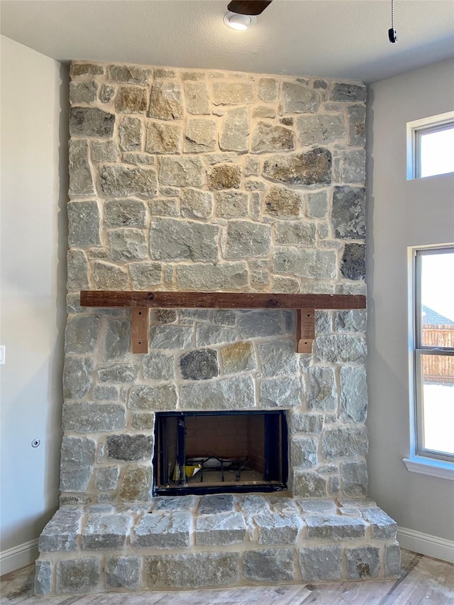 room details featuring hardwood / wood-style floors and a large fireplace