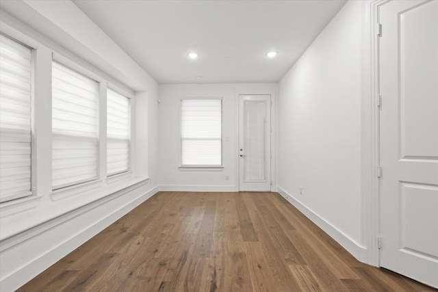 interior space with dark hardwood / wood-style flooring and plenty of natural light