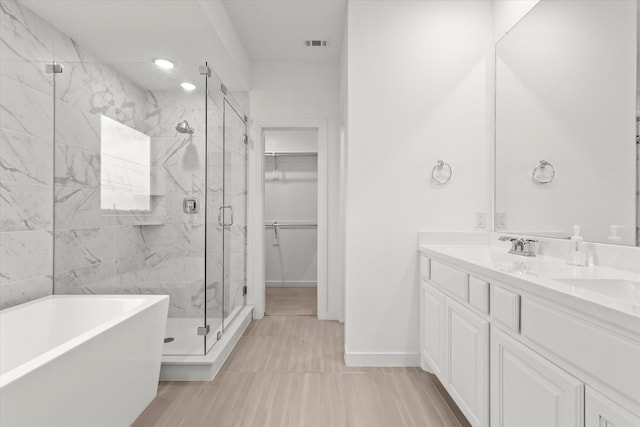 bathroom featuring vanity and separate shower and tub