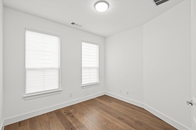 empty room with wood-type flooring