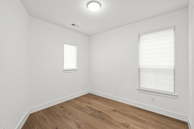 spare room featuring hardwood / wood-style floors