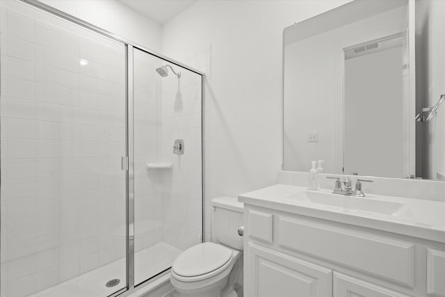 bathroom with vanity, toilet, and walk in shower