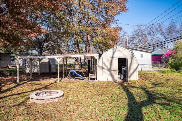 view of outdoor structure with a yard and a fire pit