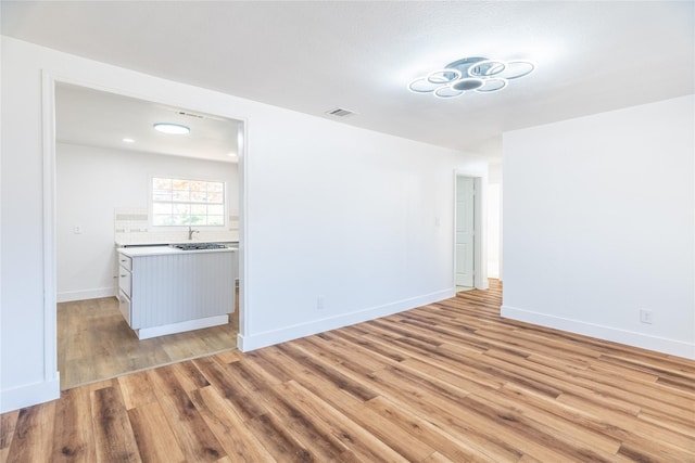 empty room featuring light hardwood / wood-style flooring and sink