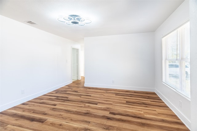 spare room with wood-type flooring