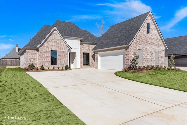 view of front facade with a front yard and a garage