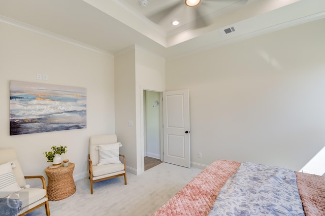 carpeted bedroom with a raised ceiling, ceiling fan, and ornamental molding