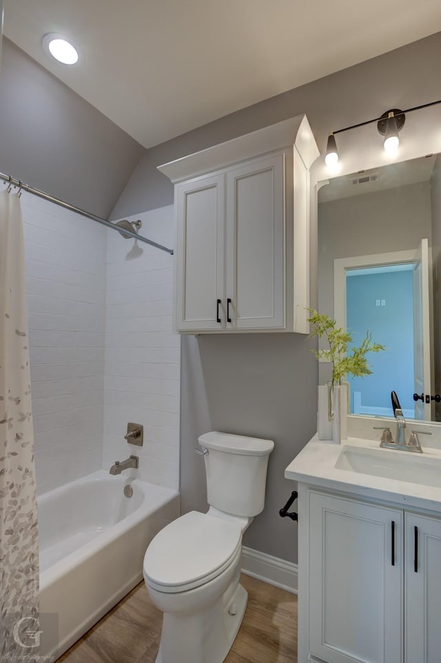 full bathroom with toilet, shower / bath combo with shower curtain, lofted ceiling, and hardwood / wood-style flooring