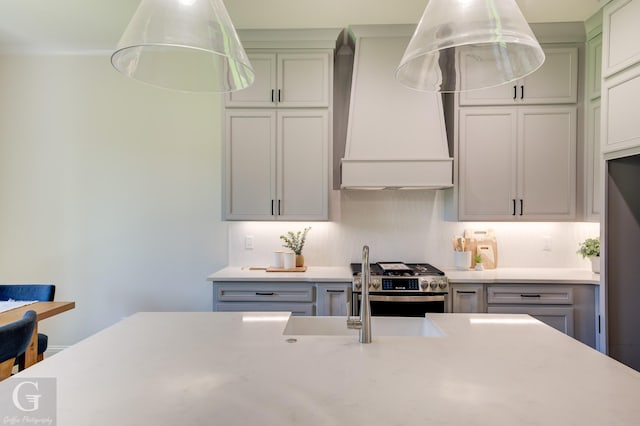 kitchen featuring high end stainless steel range and custom range hood