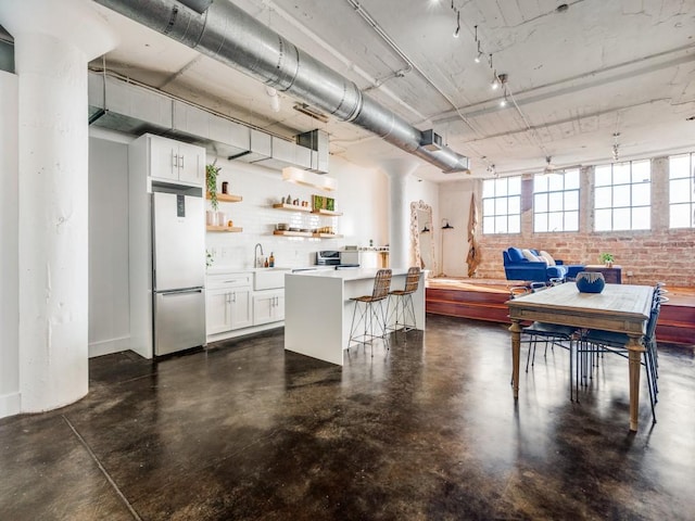 dining area featuring brick wall