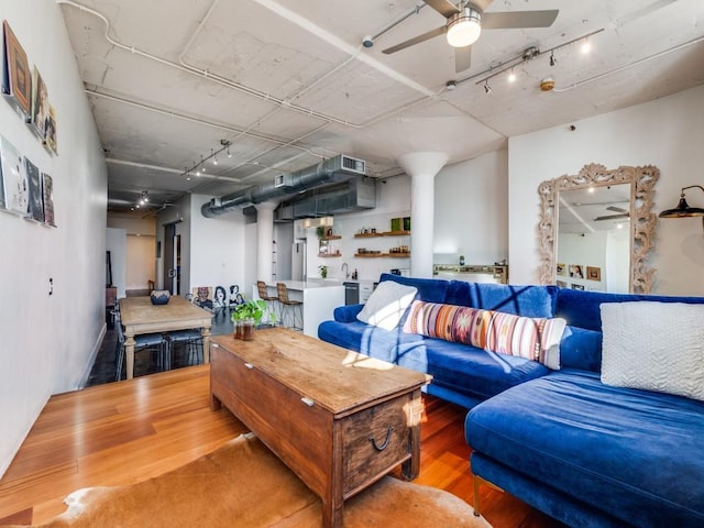 living room featuring hardwood / wood-style flooring and ceiling fan