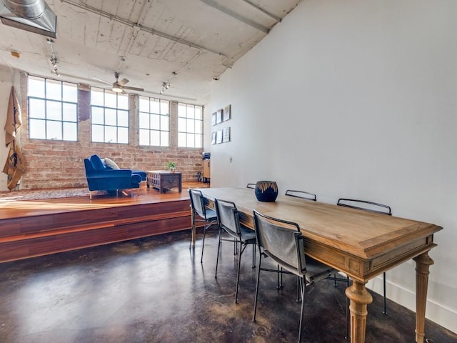 office featuring ceiling fan and brick wall