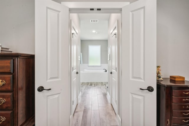 hallway featuring light wood-type flooring