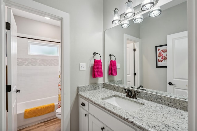 full bathroom with wood-type flooring, vanity, toilet, and shower / tub combo with curtain