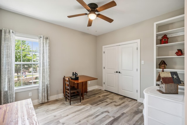 home office featuring ceiling fan and light hardwood / wood-style flooring