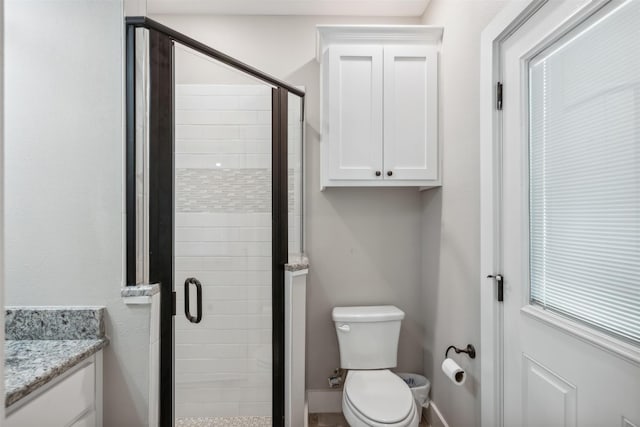 bathroom with vanity, toilet, and walk in shower