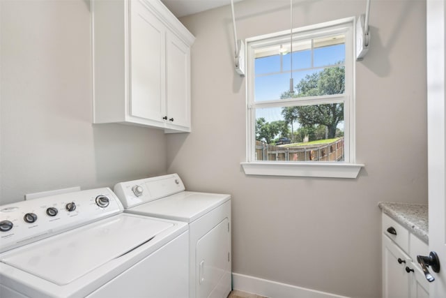 laundry room with cabinets and washing machine and dryer