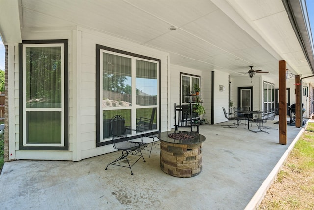 view of patio featuring ceiling fan and an outdoor fire pit