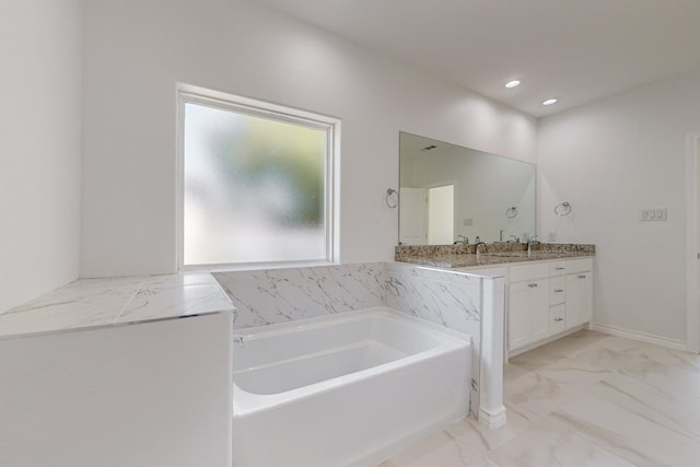 bathroom featuring vanity and a tub