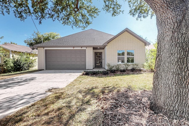 ranch-style house featuring a garage and a front lawn