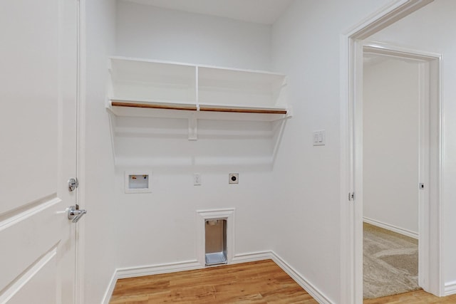 washroom featuring washer hookup, hookup for an electric dryer, and light hardwood / wood-style floors