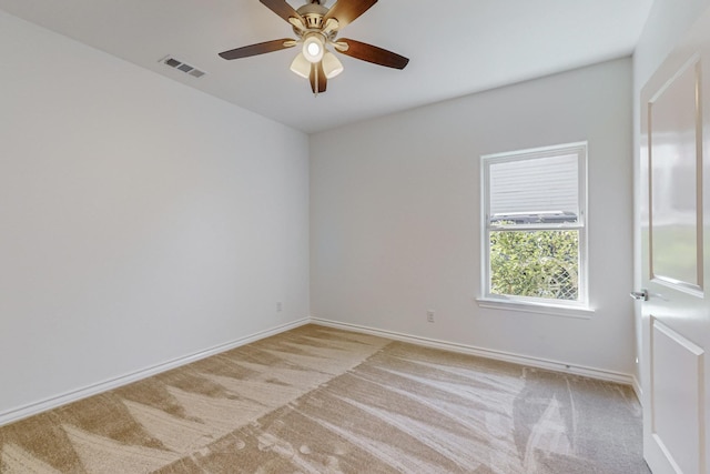 empty room featuring light carpet and ceiling fan