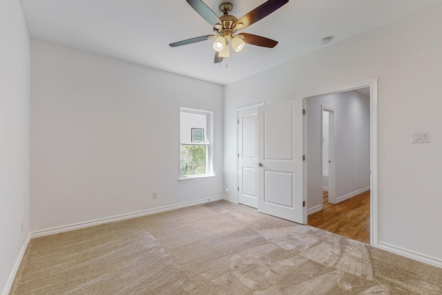 unfurnished bedroom with ceiling fan and light colored carpet