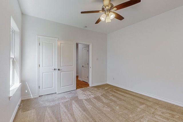 unfurnished bedroom with light carpet and ceiling fan