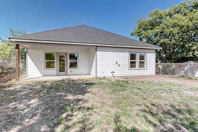 back of property featuring a yard and a patio area