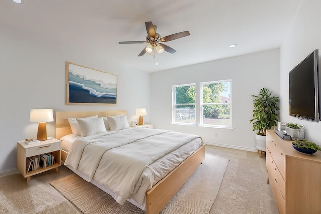 bedroom featuring ceiling fan and light colored carpet