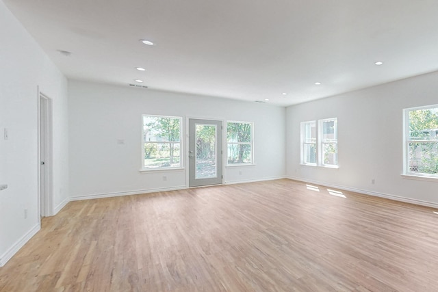 unfurnished room with light wood-type flooring